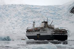 12 Zodiacs Reboarding The Quark Expeditions Antarctica Cruise Ship With Astudillo Glacier Towering Behind.jpg